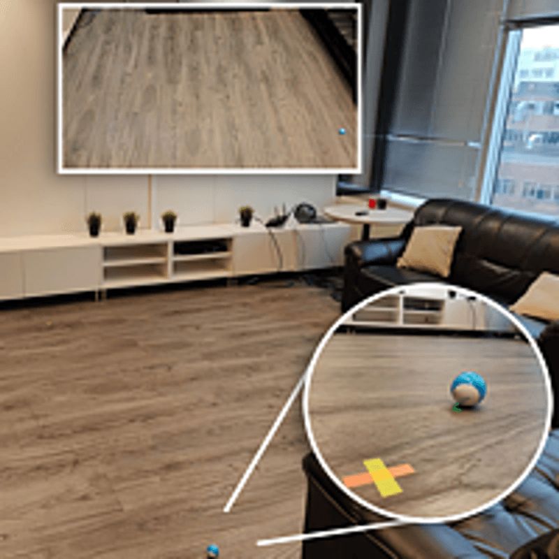 Room used as an OpenHPS test environment with a tracked robot on a marked floor grid
